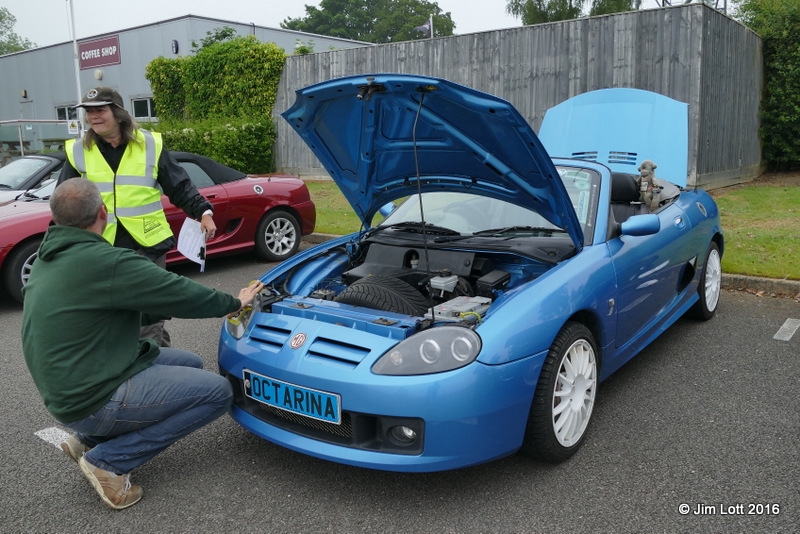Antony Pope with his Celestial Blue MG TF, "Octarina" chatting to Carole Brown the assistant scrutineer.